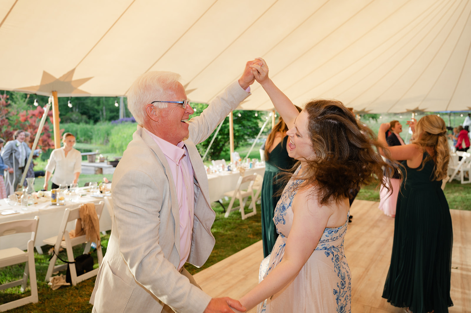 Guests dancing at outdoor tent wedding